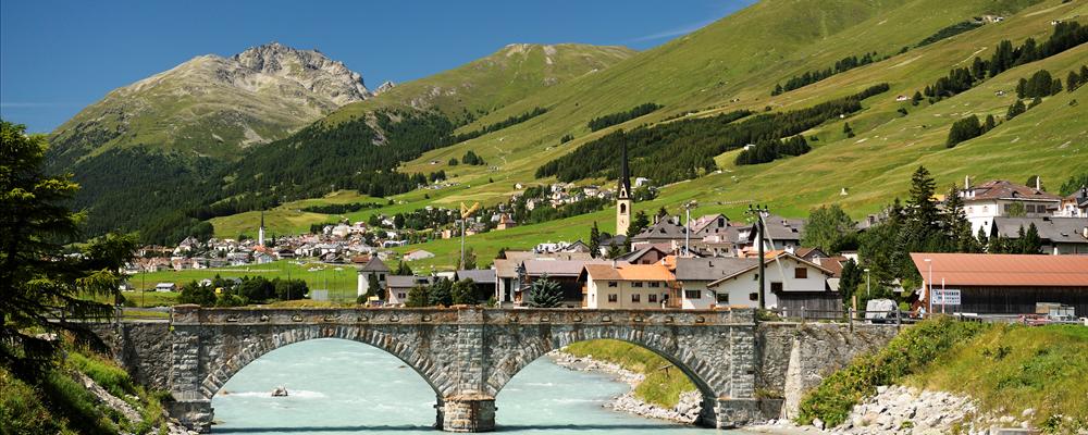 The river Inn with the bridge of the village of S-chanf with nice Engadine weather.